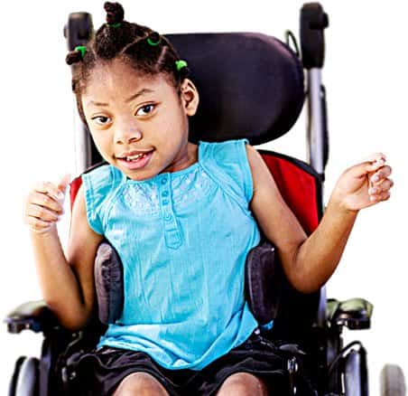 A young girl, smiling in a wheelchair.