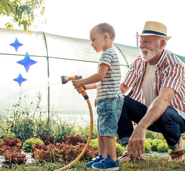 Teaching moments in the garden: a child learns the art of nurturing plants while their grandfather offers guidance from nearby.