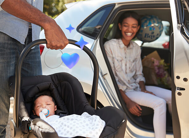 Safe travels: Mom and dad with baby in car seat carrier