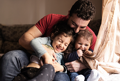 father with two children in house