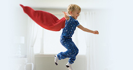 child playing wearing a cape