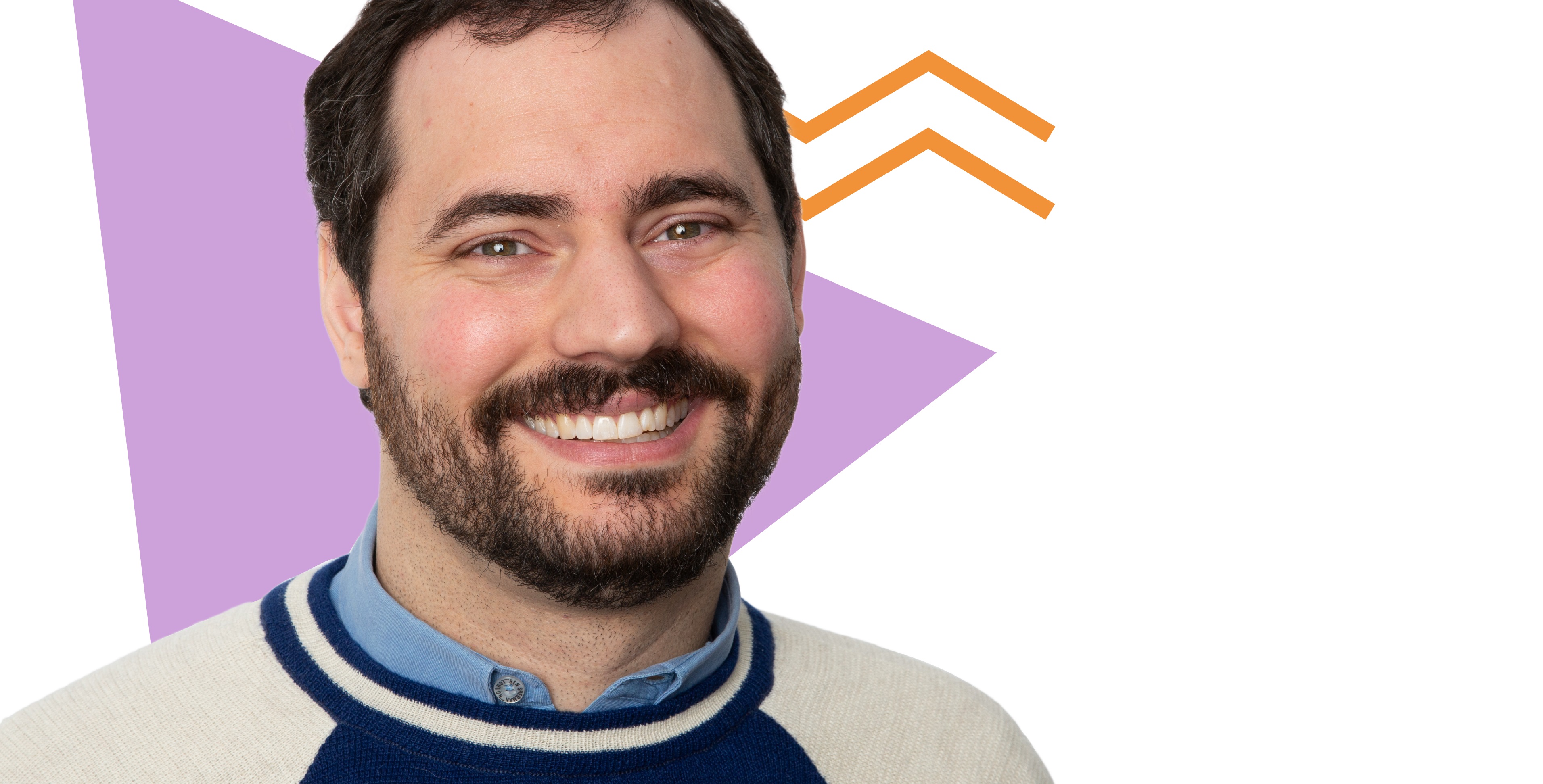 White male with a dark brown beard in his 20's smiling in front of a purple, orange and white illustrated abstract background.
