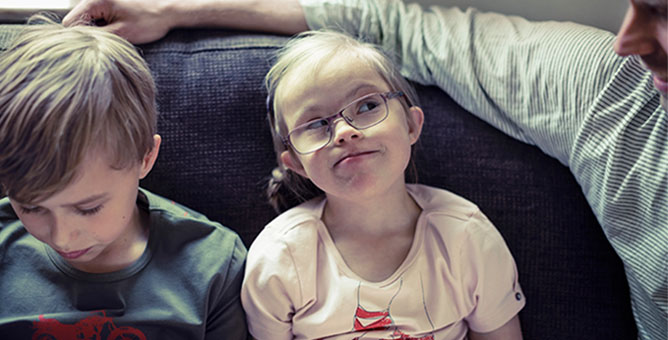 Dad, son and daughter sitting on the couch